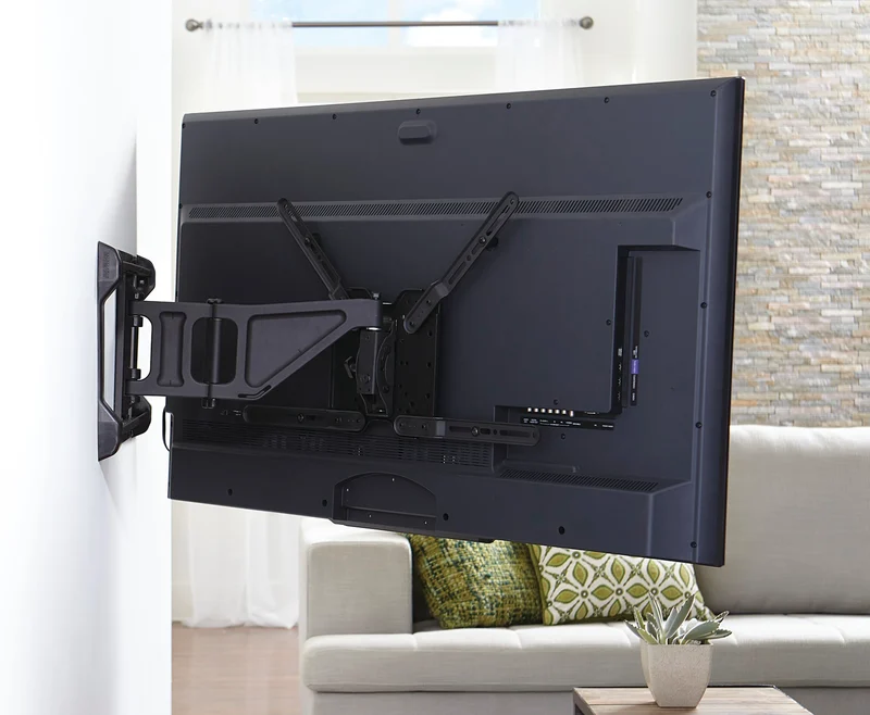 Flat screen TV mounted on a full-motion bracket